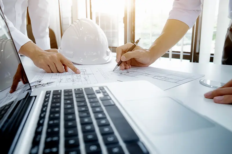 Engineers working on blueprints